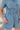 Frontal View of the Heading South Romper that features a blue colored material, a collar neckline, a short cuffed sleeve, a button-up front, two front pockets at the chest, a cinched waist, two side pockets, cuffed bottom hem, and two back pockets.