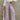 Front view of model wearing the Emily Lavender Wide Leg Pants which features acid lavender denim-like fabric, two front pockets, a front zipper with a button closure, belt loops, two back pockets, and wide legs.