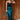 Full body view of model wearing the Lainey Green Slit Midi Skirt which features teal and black shimmer pleated fabric, midi length, slit on the side, thigh length fuchsia lining and elastic waistband.