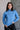 Front view of model wearing the Gabriela Blue Turtleneck Sweater that has blue knit fabric, ribbed hem, a turtleneck neckline, dropped shoulders, and long sleeves with cuffs.