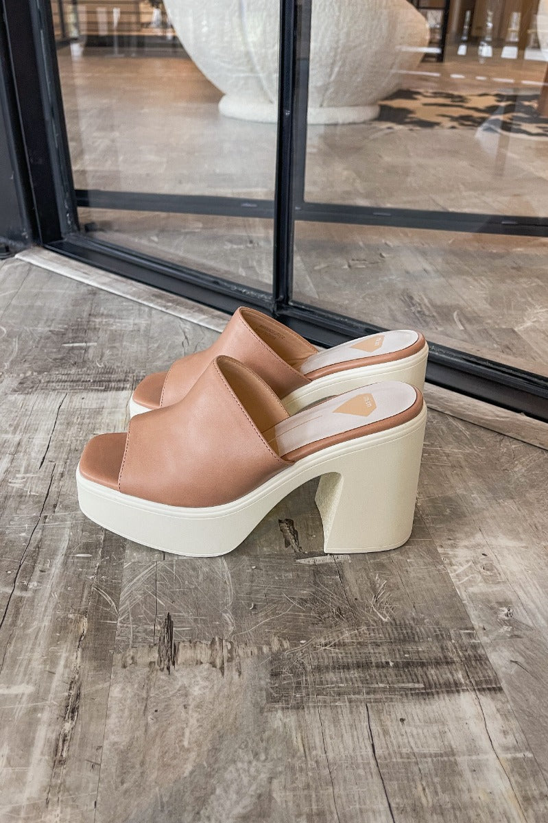 Side view of the Sienne Block Heel which features a slip-on style, two-tone design, white sole with a block heel and nude/pink upper.