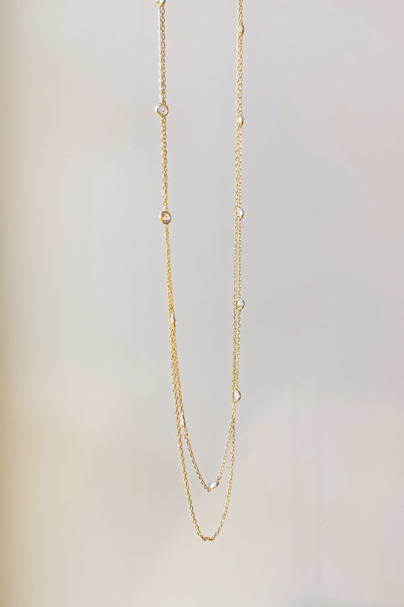 Front view of the Fearless Layered Necklace which features a gold double layer chain link with circle clear stones.