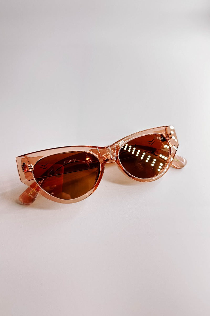 Front view of the I-Sea: Carly Sunglasses in Watermelon & Brown which features cat-eye shaped light pink frames with brown lenses.