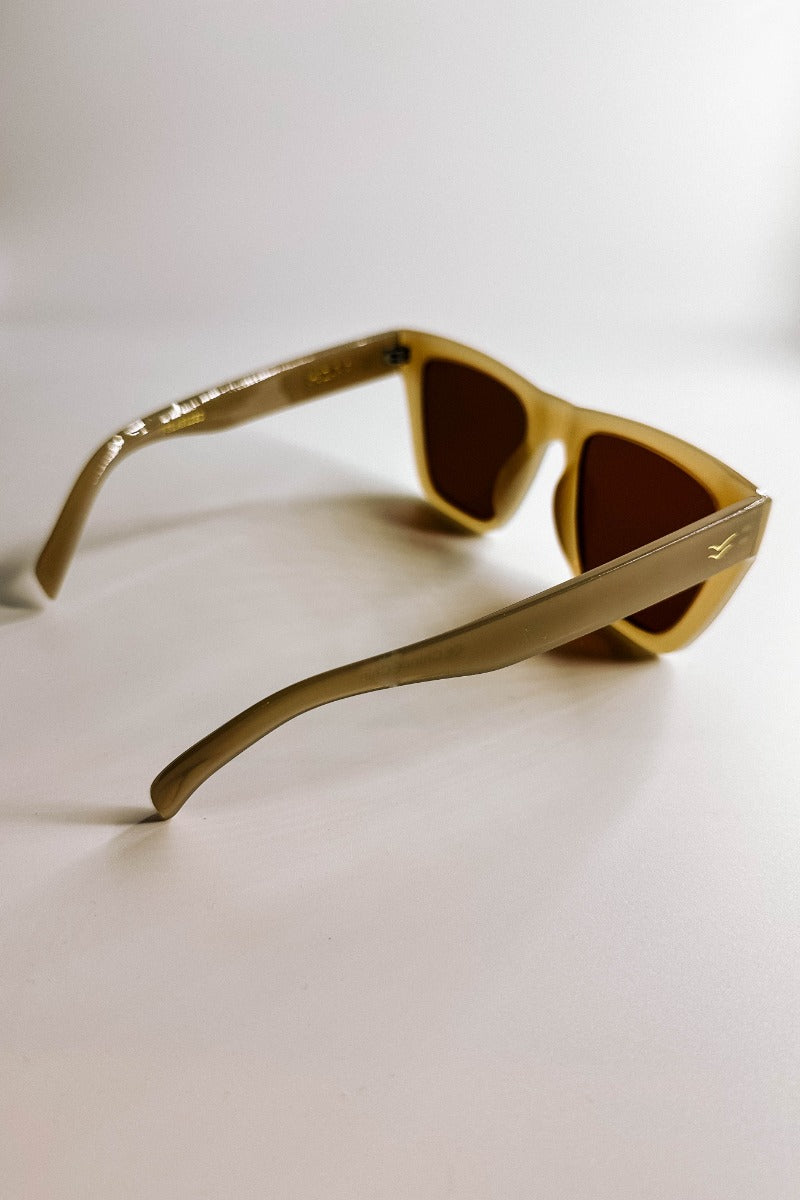 Side view of the I-Sea: Ava Sunglasses in Oatmeal & Brown which features light taupe frames with brown lenses.