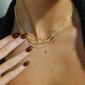 Close up view of model wearing the Nora Gold Layered Necklace which features seven, gold, skinny, slinky, layers with adjustable clasp closure.