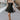 Full body front view of model wearing the Love Of Mine Dress that has black sheer fabric, mini length, black lining, a strapless sweetheart neckline with pleating, and a smocked back.