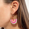 Side view of model wearing the Summer Heat Beaded Earrings which features hot pink, light pink and orange beads, designed in a gold shaped hoop.
