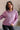 front view of model wearing The Chloe Purple Hoodie Long Sleeve Sweatshirt that has light purple cotton fabric, a thick hem, a high neckline with a hood attached and drawstring ties, dropped shoulders, and long sleeves with cuffs.