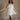Full body front view of model wearing the Kensley White Floral & Sequin Strapless Mini Dress that has white sheer fabric, a tiered body, a floral print outlined with sequins, and a sweetheart strapless neck.
