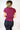 Back view of model wearing the Robin Burgundy Athletic Short Sleeve Top which features burgundy athleisure fabric, monochrome stitch details, a scooped neckline, and short sleeves.