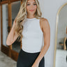 Front view of model wearing the Close To You Tank in Ivory which features ivory knit fabric with a lining, a round neckline, and a sleeveless body.