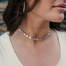 Model is wearing the Londyn Silver Rhinestone Choker that features rectangular clear rhinestones set in silver and an adjustable hook/chain closure.