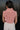 Back view of model wearing the Jordyn Orange & White Sleeveless Turtleneck Sweater which features orange and white cable knit fabric, a cropped waist, a turtleneck neckline, and a sleeveless design.