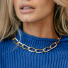 Front view of model wearing the Quinn Gold Chain Link Necklace which features single large chain, shiny gold links.