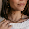 Close up view of model wearing the Elara Gold Chain Link Necklace which features gold marquise shaped chain.