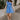 Full body view of model wearing the Phoebe Blue One- Shoulder Smocked Mini Dress which features blue light weight fabric, mini length, blue lining, upper smocked details, ruffle details, one shoulder ruffle strap and sleeveless.