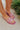 Ariel view of model wearing the Think Pink Sandals which features pink transparent coloring, light pink matte chain link details and slip on.
