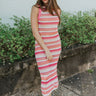 Front view of model wearing the She's Everything Open-Knit Dress that ahs open knit fabric with a hot pink, pink, orange, peach and white striped pattern, midi length, a high round neckline, and a sleeveless design.