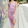 Full body view of model wearing the Blaire Satin Midi Dress which features lavender satin fabric, midi length, a slit on the side, exterior boning and mesh details, pleated upper fabric, a sweetheart neckline, adjustable straps, and a monochromatic back z