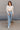 Full body front view of model wearing the The On Your Mind Top in Cream that has cream knit fabric, a cropped waist, a round neckline and long sleeves.
