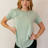Front view of model wearing the Lillie Mint Green Basic Short Sleeve Top that has mint green knit fabric, a scooped hem, a round neckline and short sleeves.