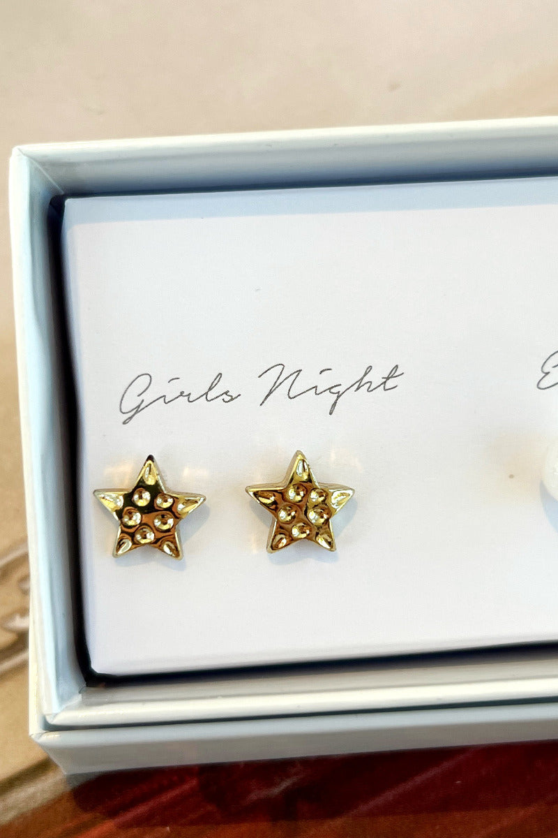 Close-up view of the 'girls night' gold star earrings.