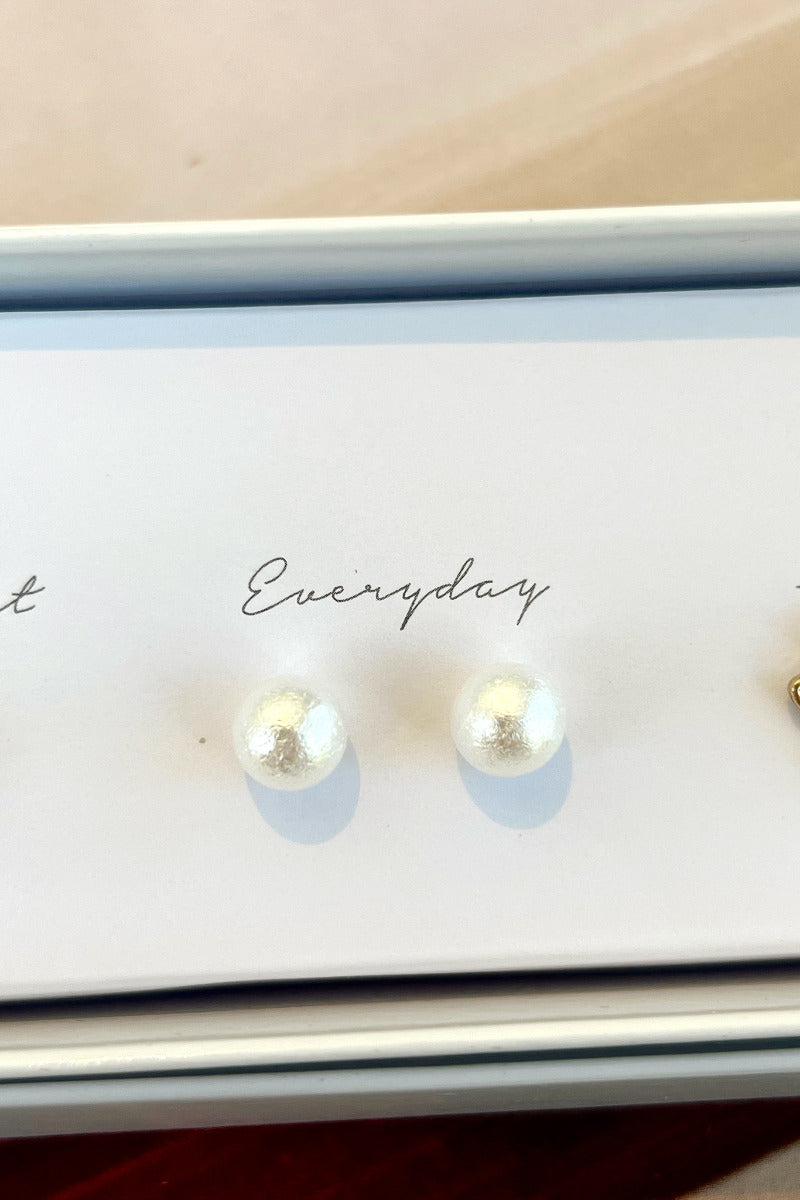 Close-up view of the 'everyday' white pearl earrings.