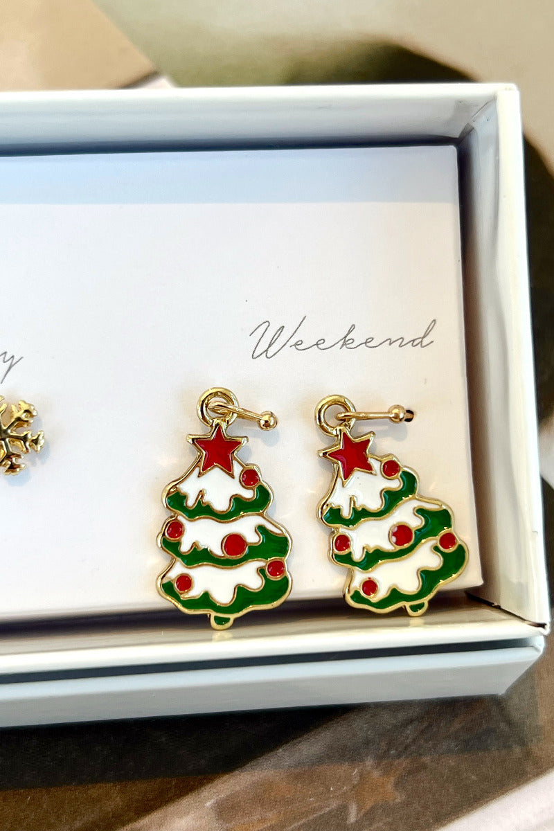 Close-up view of the 'weekend' green, white, and red christmas tree earrings.