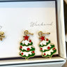 Close-up view of the 'weekend' green, white, and red christmas tree earrings.