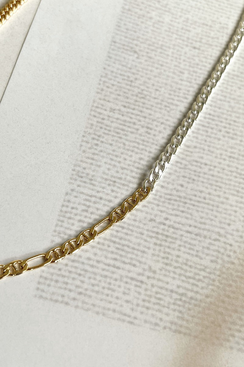 Close up view of the Mixed Emotions Necklace which features mixed metal chain with gold and silver.