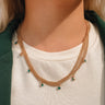 The Meet Me In The Middle Necklace In Green is a multi-layered necklace featuring green jewel pendants through out finished with a link and clasp closure.