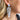 Close up view of model wearing the Winter Dreams Earrings which features blue and white marble, leaf shaped dangles.