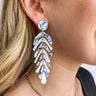 Close up view of model wearing the Winter Dreams Earrings which features blue and white marble, leaf shaped dangles.