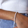 Front view of model wearing the In Love Pearl Bracelet which features pearls linked with a gold chain design.