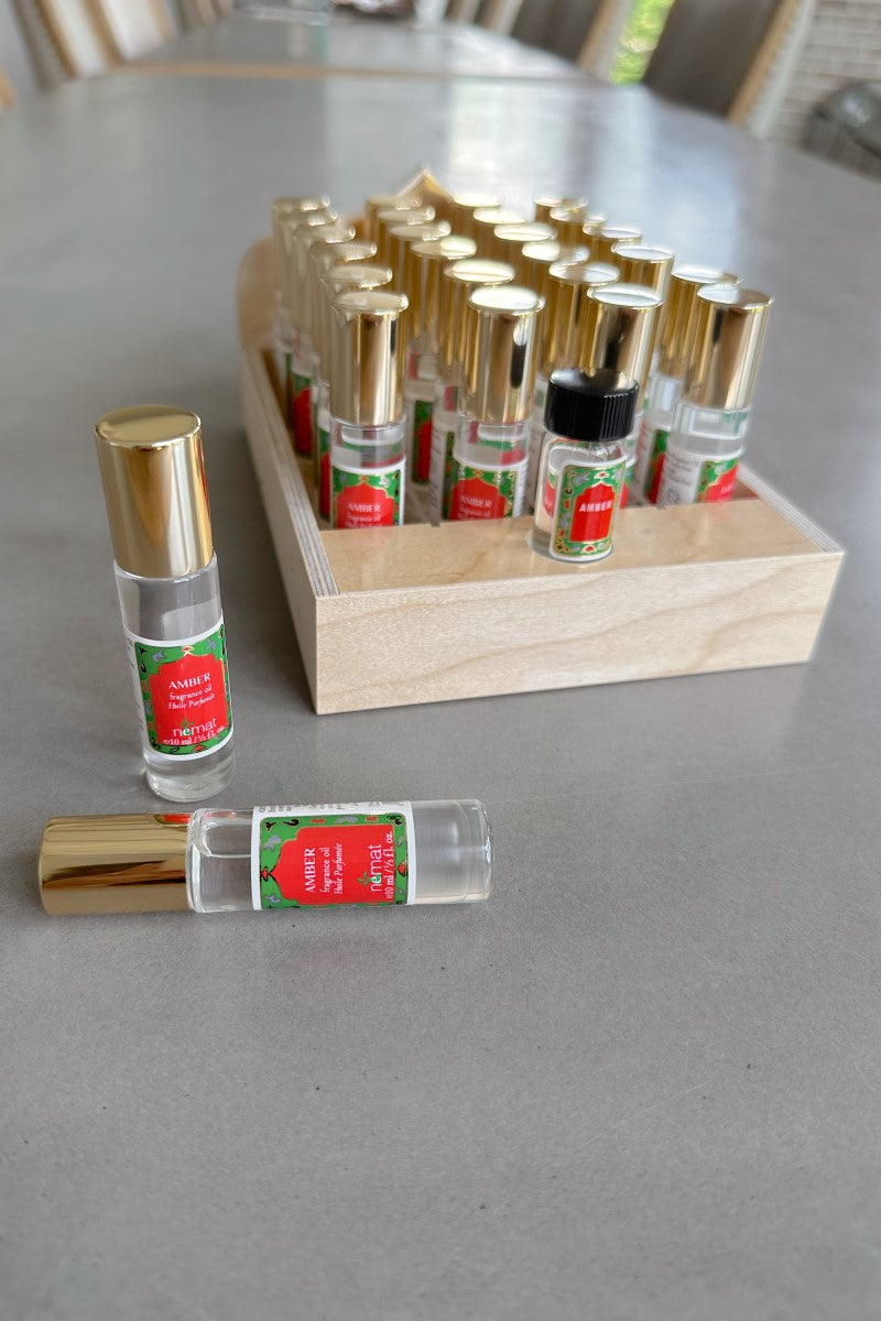 Image of display of mutiple Nemat Amber Fragrance Oil - 10 mL Roll Ons.