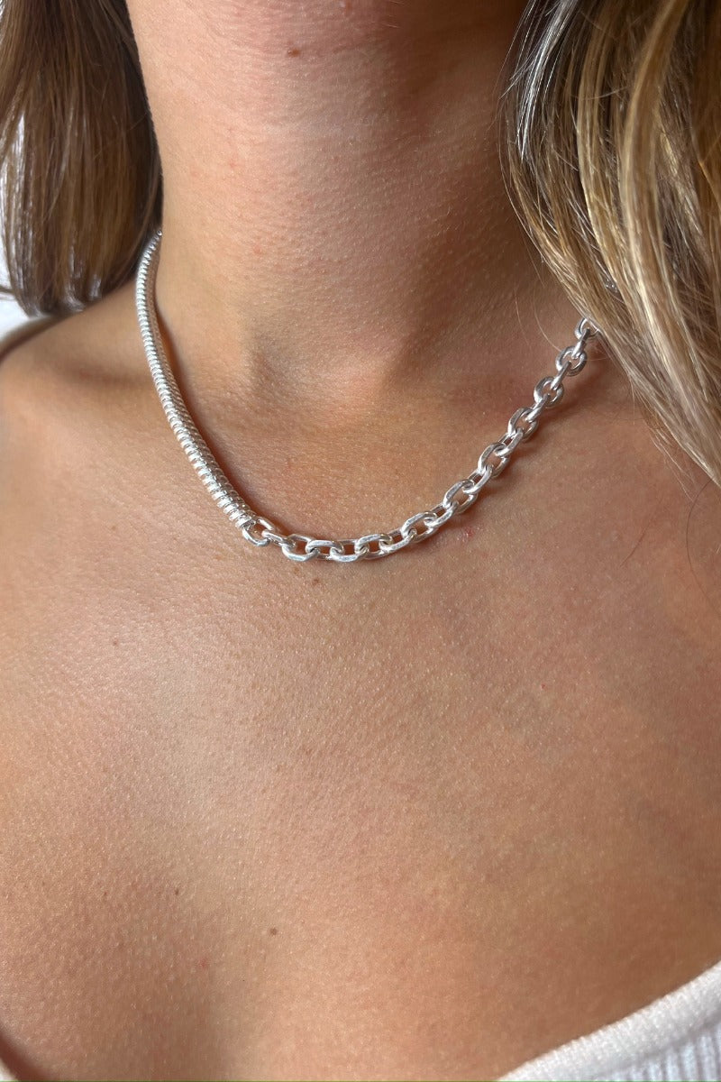Front view of model wearing the Half And Half Necklace in Silver which features half of a silver chain link with half of a silver braided link.