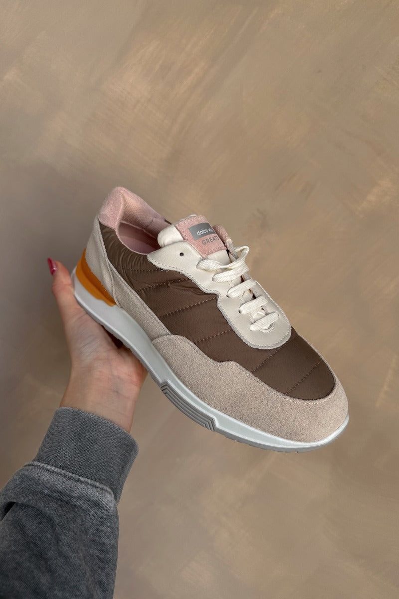 Front view of the Evana Sneaker which features a color-block design with taupe, cream, orange and light pink fabric, rubber outsole, lace-up tie design, mesh lining and 0.8" platform height.