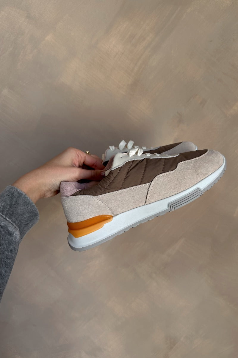 Side view of the Evana Sneaker which features a color-block design with taupe, cream, orange and light pink fabric, rubber outsole, lace-up tie design, mesh lining and 0.8" platform height.
