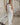 Image shows woman in a white maxi dress.