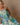 Woman wearing dress to feature 2024 travel dress trends. 