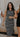 image shows 3 women with arms interlinked. Left woman is wearing a white romper, middle woman is wearing a striped midi dress, and the right woman is wearing a black romper.