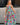 Full body front view of female model wearing a colorful printed maxi dress.