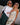 two models standing arm in arm wearing a top/skirt and dress