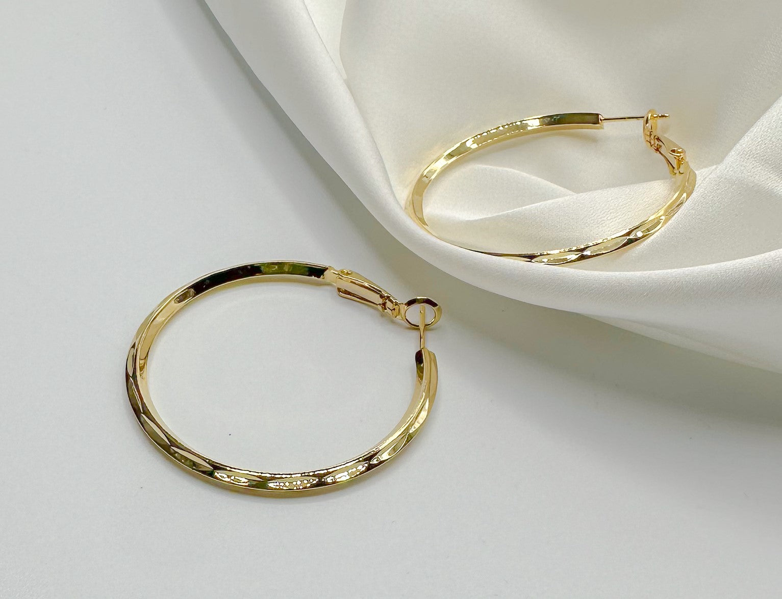 Top view of Julissa Gold Hammered Hoop Earrings