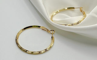 Top view of Julissa Gold Hammered Hoop Earrings