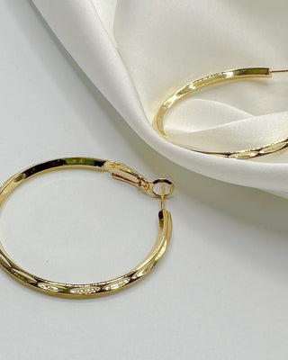 Top view of Julissa Gold Hammered Hoop Earrings