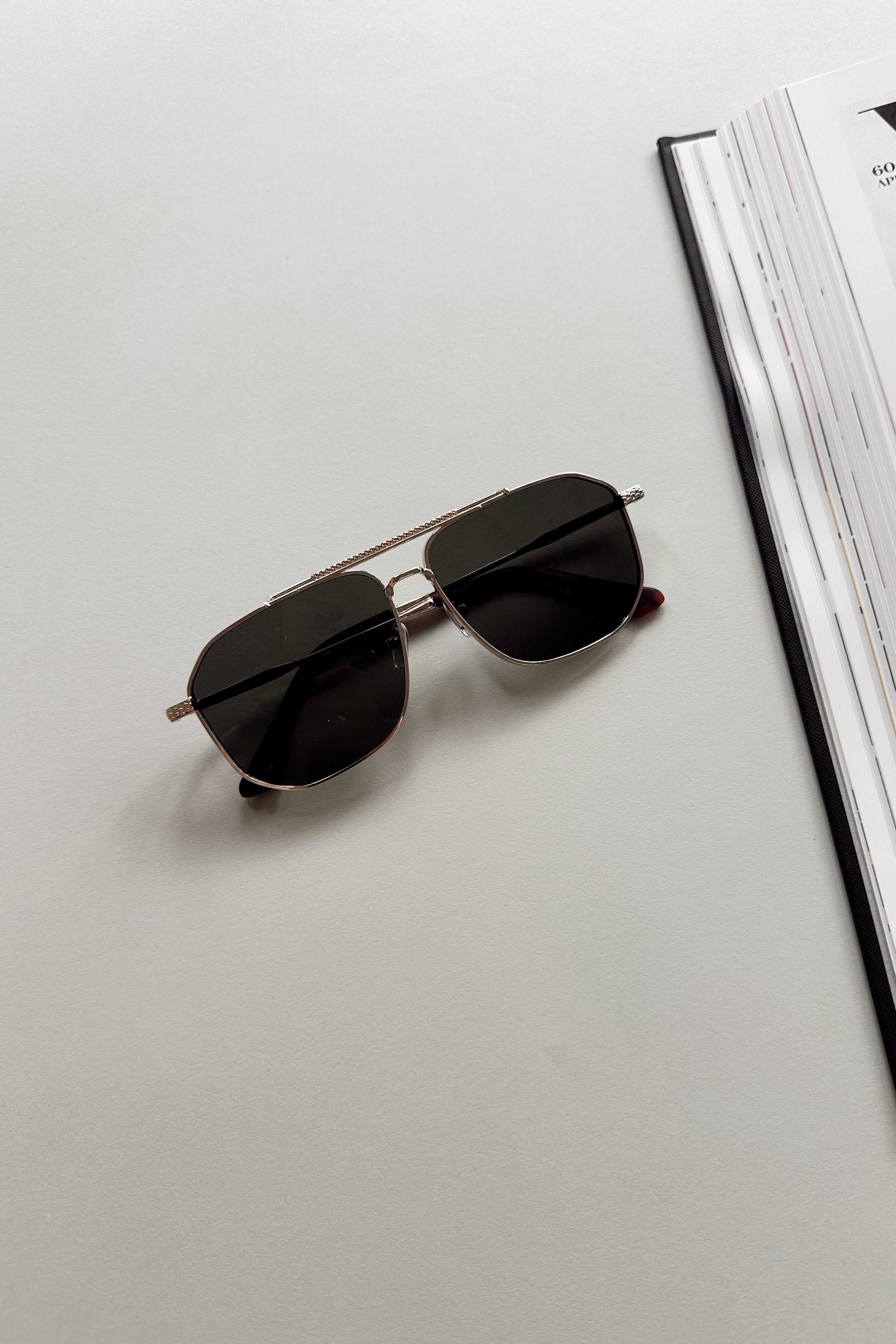 Regan Sunglasses in Gold & Black - flat lay - front