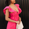 Side view of model wearing the Stella Hot Pink Ruffle Straps Mini Dress which features hot pink light weight fabric, mini length, hot pink lining, two side pockets, sweetheart neckline, ruffle straps, sleeveless and open back with tie closure.
