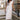Full body view of model wearing the Eliana White Floral Midi Dress which features white sheer net fabric, white floral 3D pattern, midi length, white lining, overlap plunge neckline, thick straps with tie details, sleeveless and monochrome back zipper wit