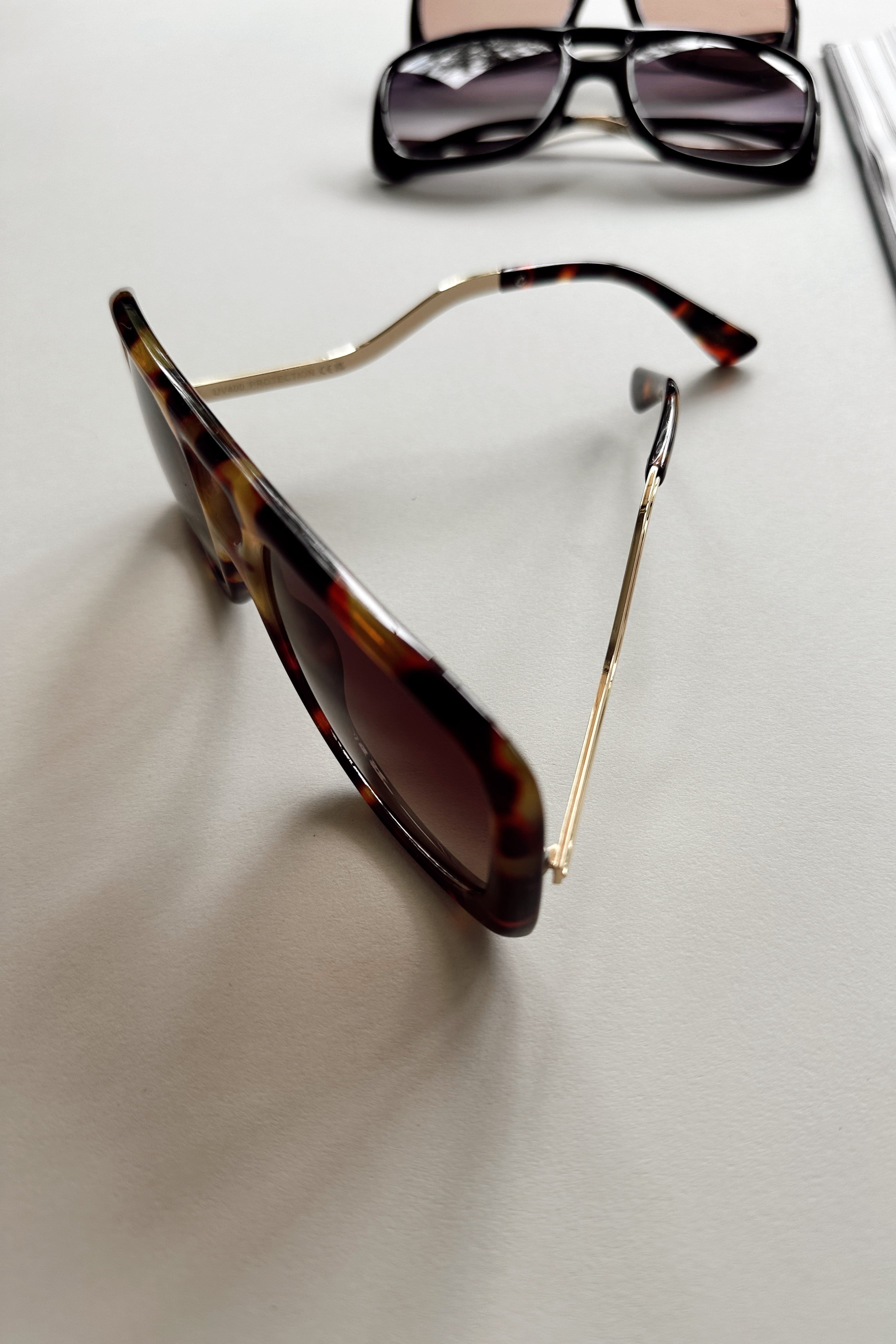 Kennedy Sunglasses in Dark Tortoise - flat lay - side view